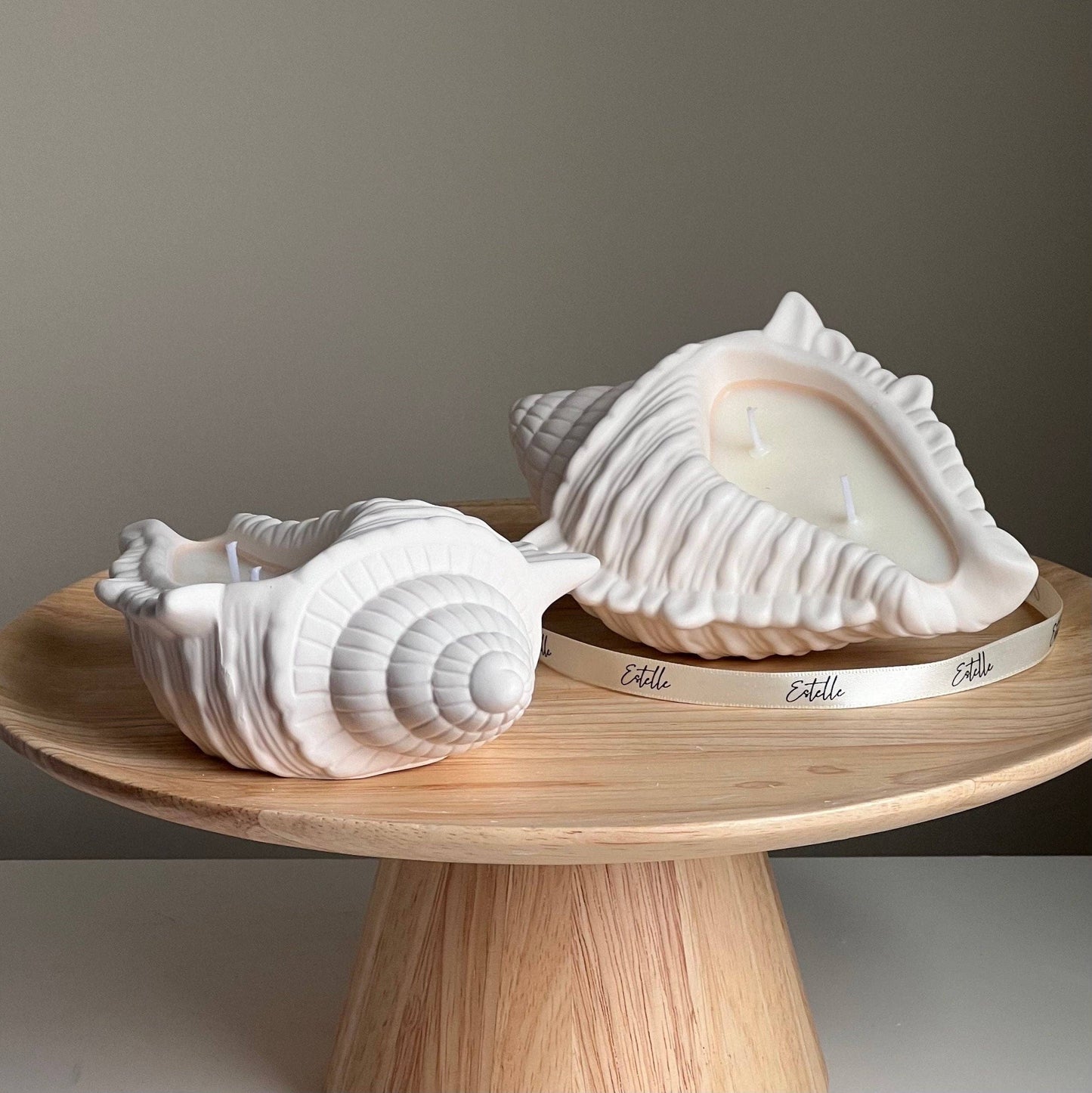 Bougie artisanale en cire de soja et coquillage, dans un contenant en Jesmonite. 